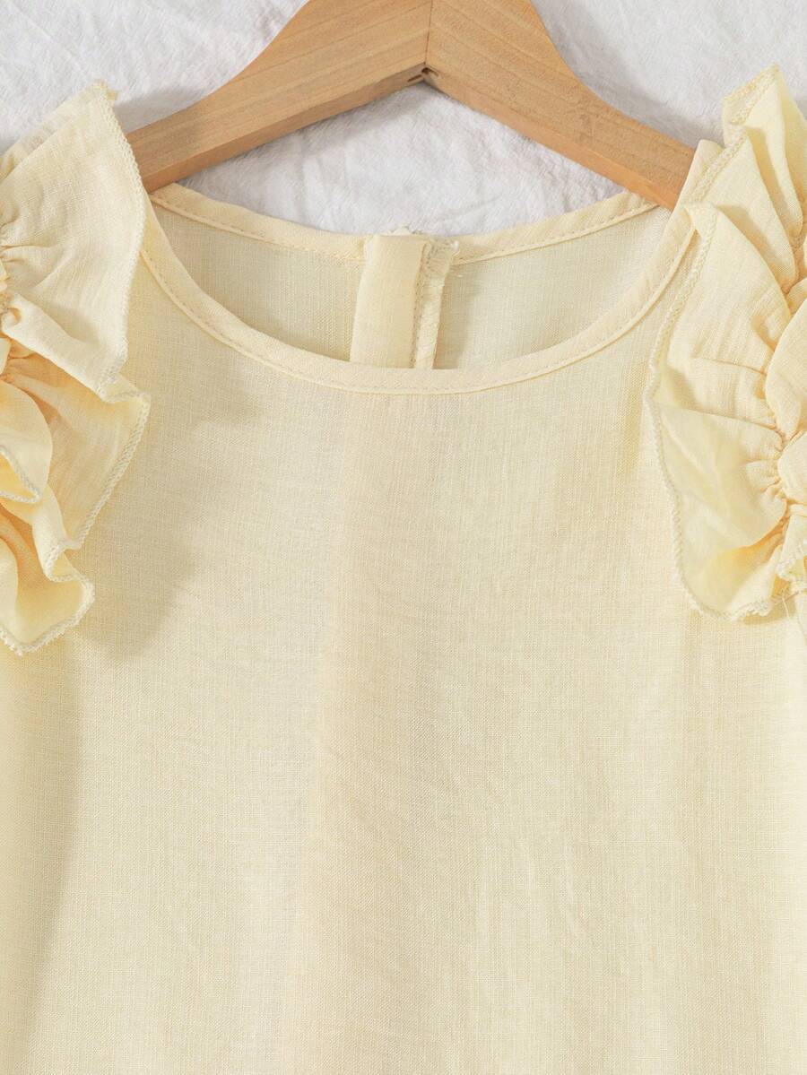 Tween girls apricot vacation midi dress featuring a round neck, cut out details, ruffle flounce accents, and geometric pattern.