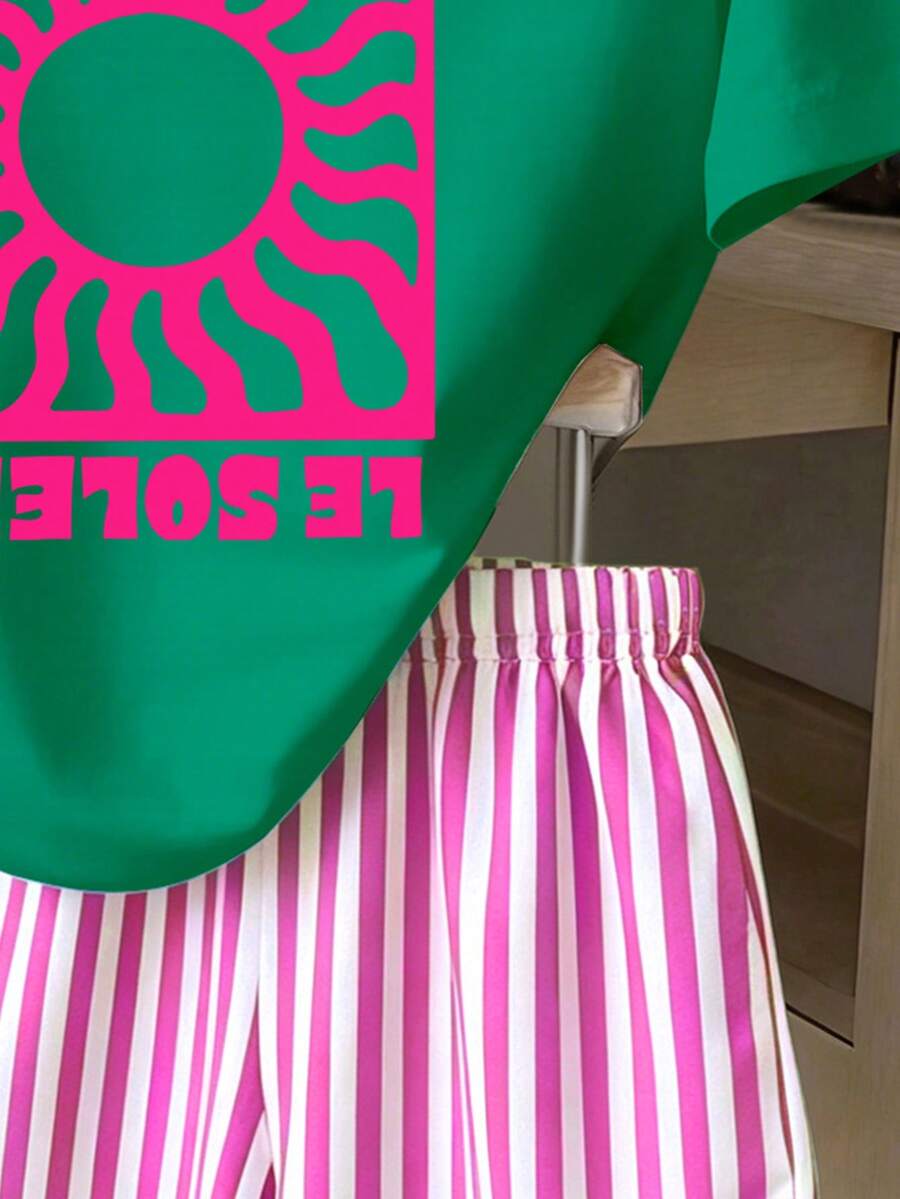 Girls' multicolor short sleeve T-shirt and shorts set featuring a cute cherry and bow print with round neck top and matching shorts.