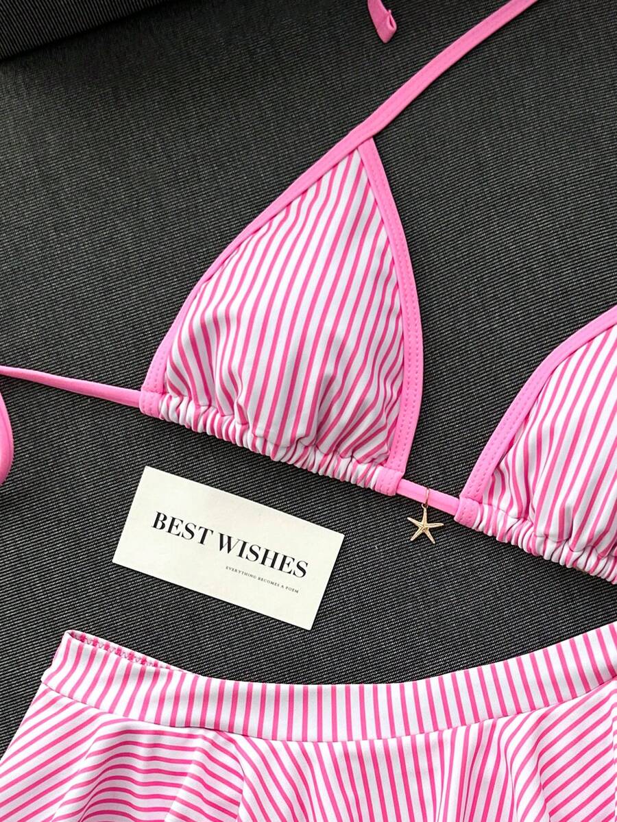 Women's 70s retro black and white polka dot bikini set featuring a halter triangle top and ultra low waist bottoms.