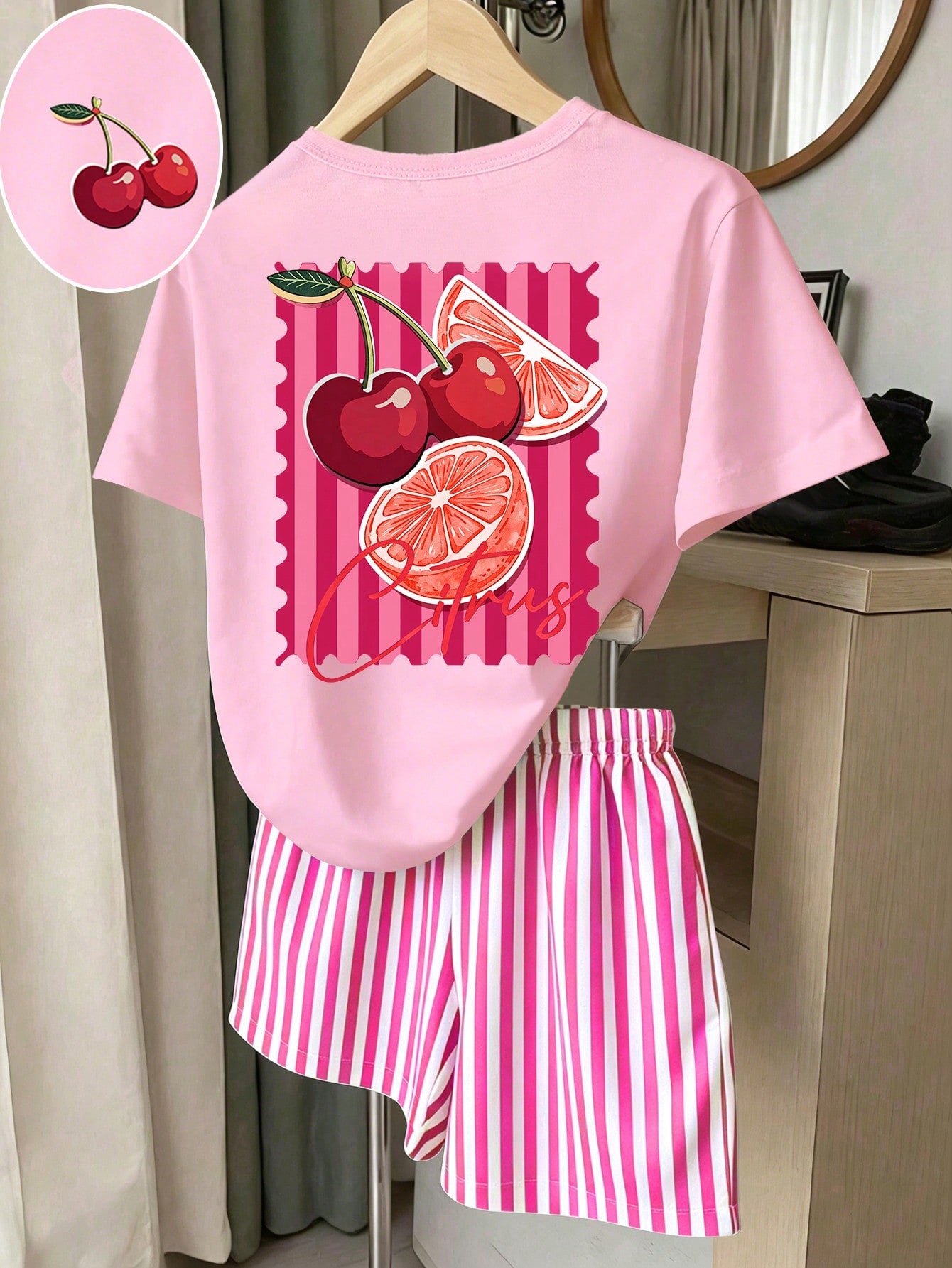 Girls' multicolor short sleeve T-shirt and shorts set featuring a cute cherry and bow print with round neck top and matching shorts.