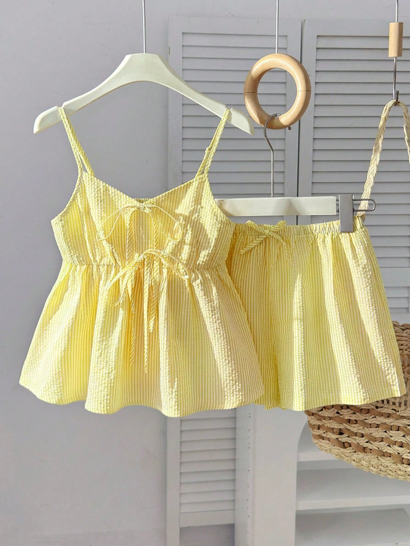 Tween girl 2-piece summer set with a black and white sleeveless striped spaghetti strap tank top with ruffle details and matching casual shorts.
