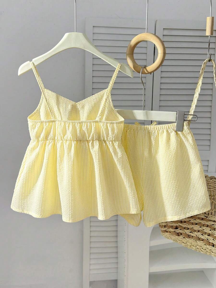 Tween girl 2-piece summer set with a black and white sleeveless striped spaghetti strap tank top with ruffle details and matching casual shorts.