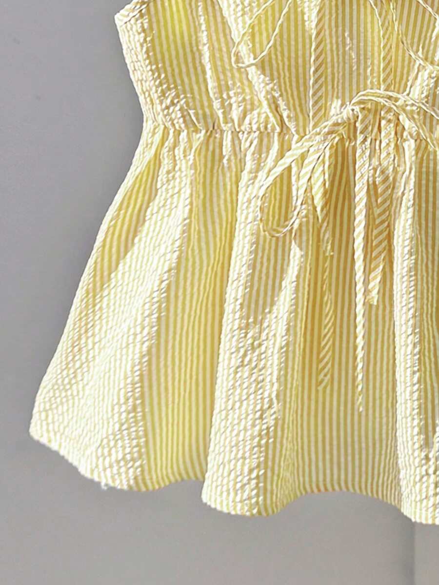 Tween girl 2-piece summer set with a black and white sleeveless striped spaghetti strap tank top with ruffle details and matching casual shorts.