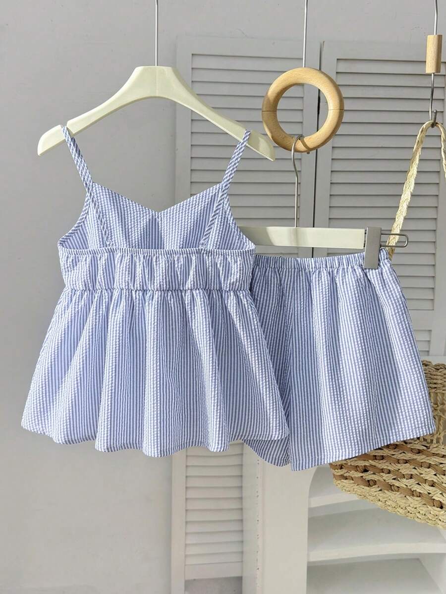 Tween girl 2-piece summer set with a black and white sleeveless striped spaghetti strap tank top with ruffle details and matching casual shorts.