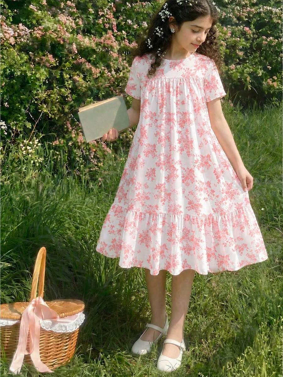 Tween girl wearing an Army Green textured short sleeve smock midi dress with round neck and ruffle flounce hem.