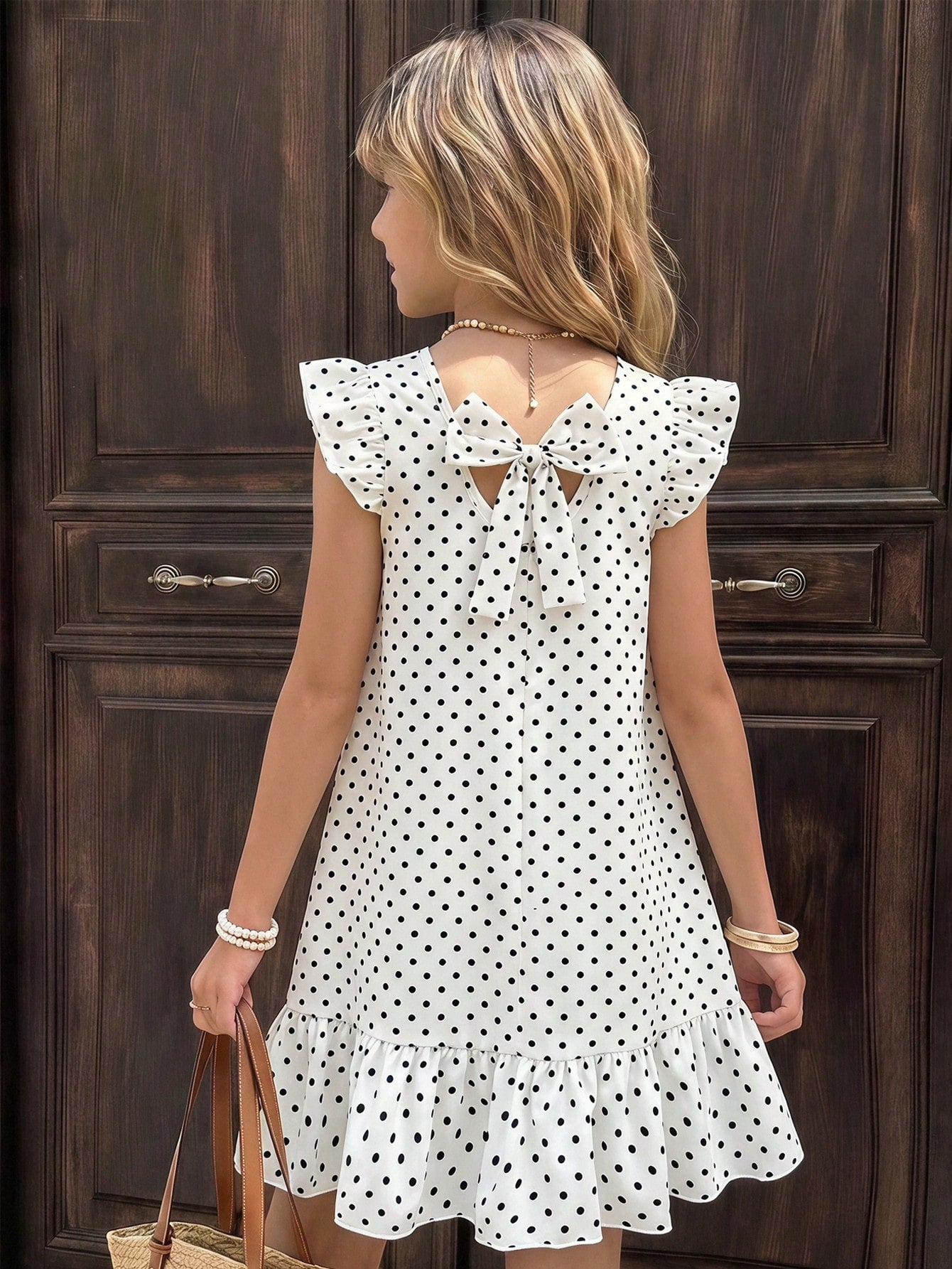 Tween girls apricot vacation midi dress featuring a round neck, cut out details, ruffle flounce accents, and geometric pattern.