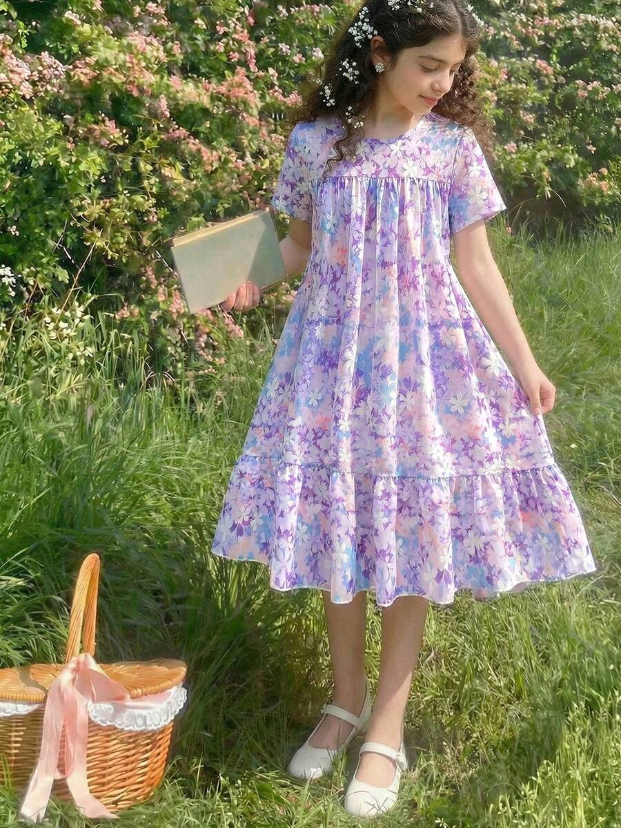 Tween girl wearing an Army Green textured short sleeve smock midi dress with round neck and ruffle flounce hem.
