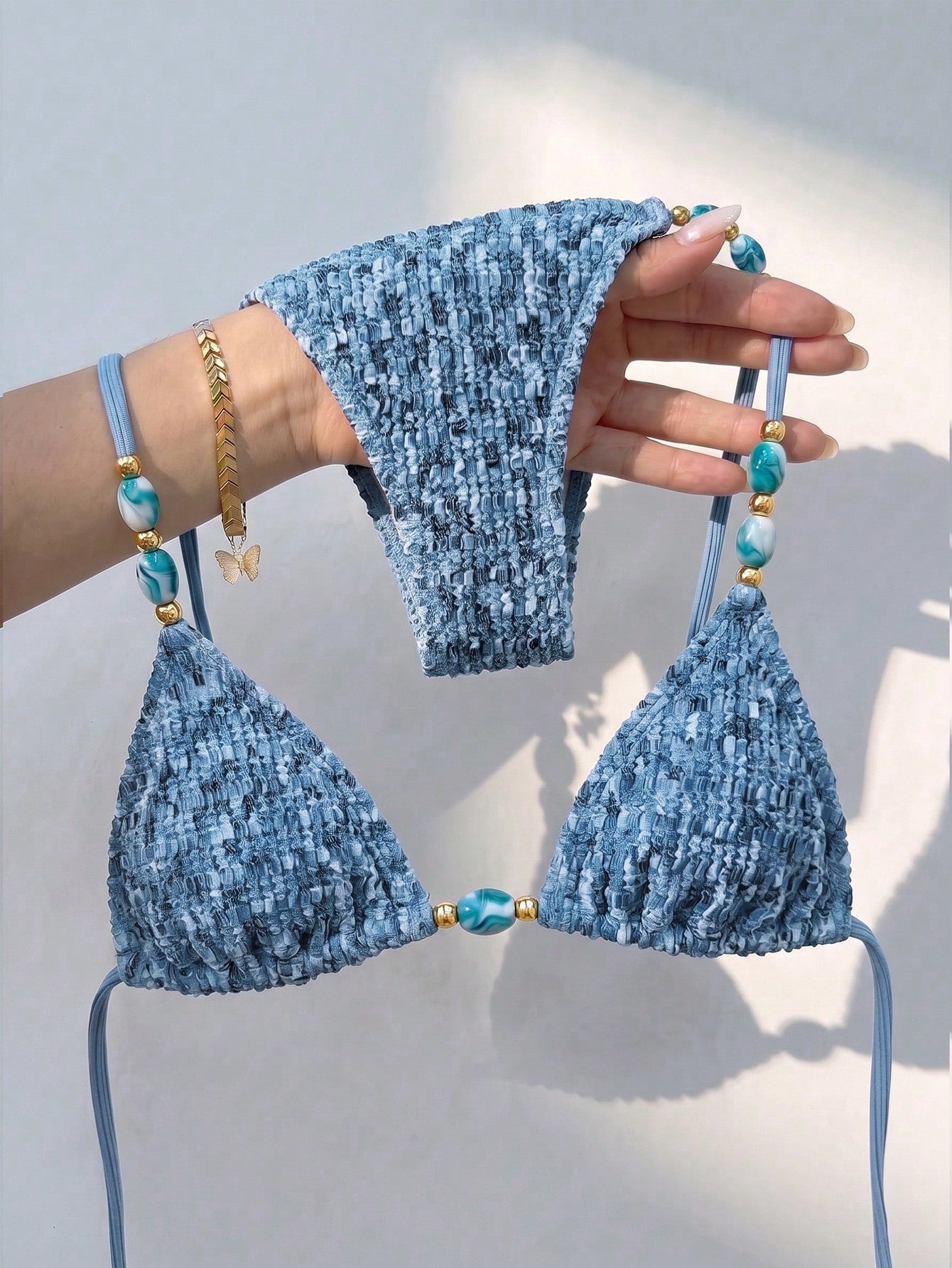 Multicolor textured beaded halter bikini set for women featuring wireless triangle cups with removable padding and ultra low waist tie side bottoms.