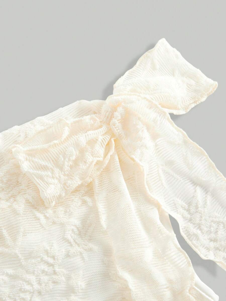 Tween girls sleeveless apricot A-line dress featuring an asymmetrical neck, contrast lace trim, and a flared hem.