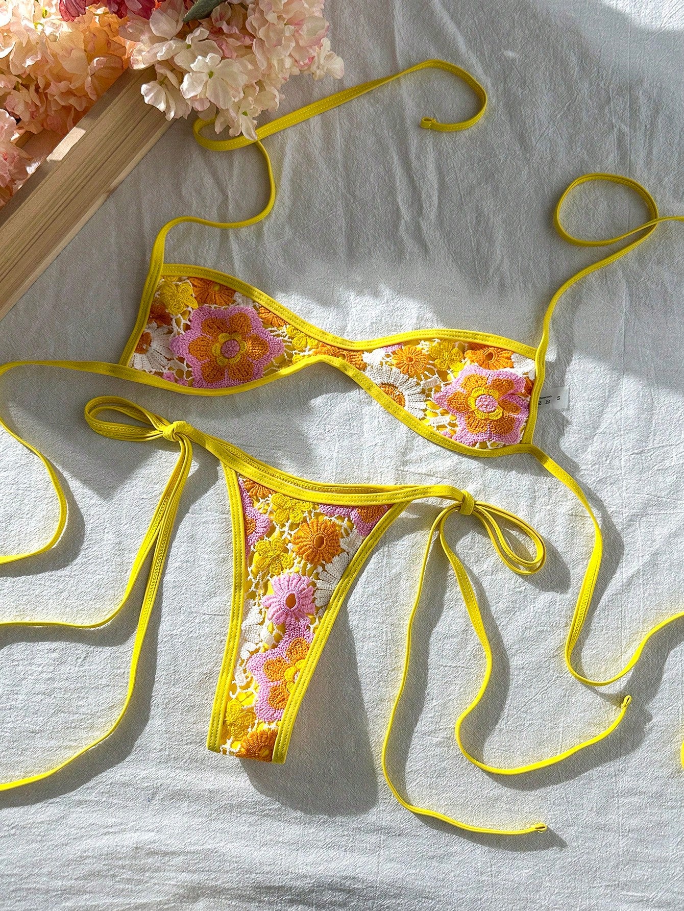 Apricot 2-piece sequin textured halter bikini set featuring a wireless top with lace-up backless ties and matching low-waist side-tie thong bottoms.