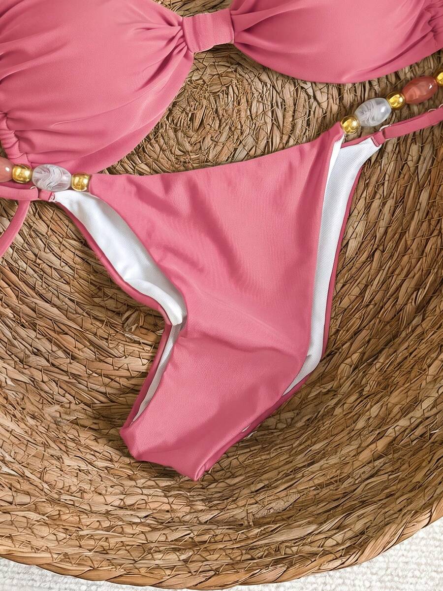 Women's green halter neck bikini set featuring color-block beaded shoulder straps, back tie detail, and high cut bottoms.