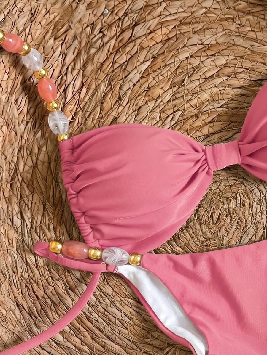 Women's green halter neck bikini set featuring color-block beaded shoulder straps, back tie detail, and high cut bottoms.