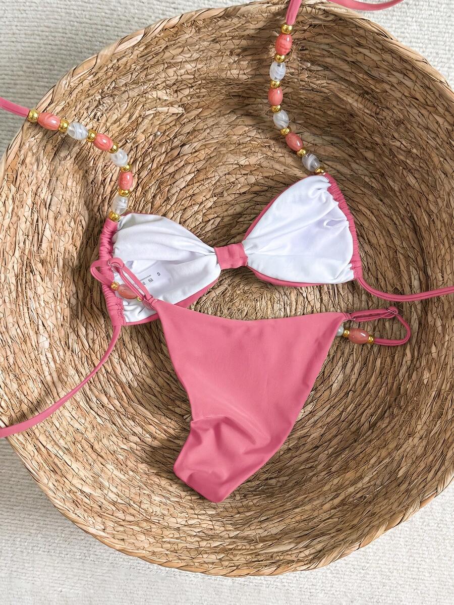 Women's green halter neck bikini set featuring color-block beaded shoulder straps, back tie detail, and high cut bottoms.