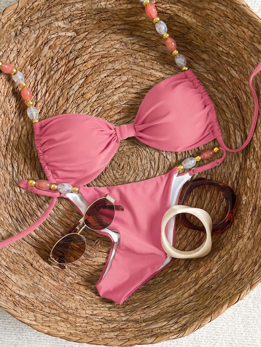 Women's green halter neck bikini set featuring color-block beaded shoulder straps, back tie detail, and high cut bottoms.