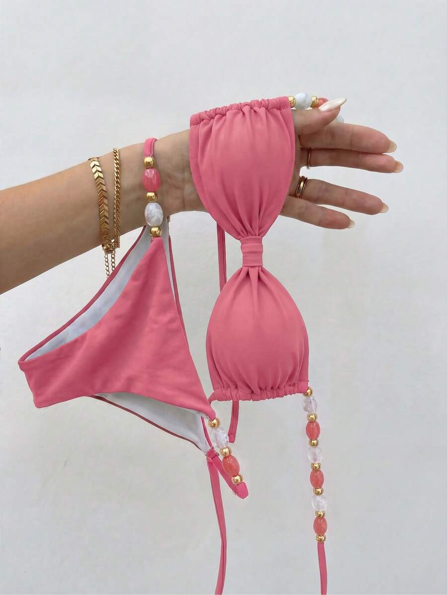 Women's green halter neck bikini set featuring color-block beaded shoulder straps, back tie detail, and high cut bottoms.