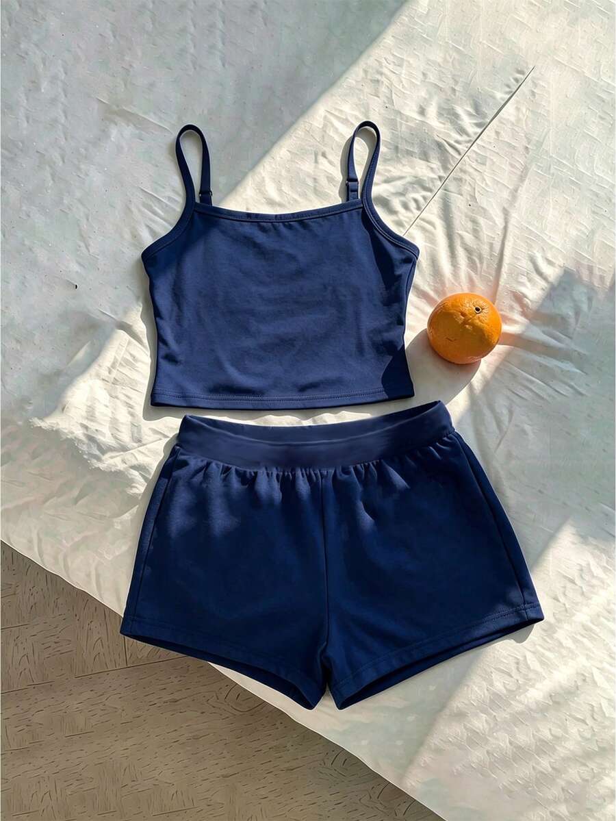 Tween girls summer 2-piece Hawaiian style outfit featuring a graphic print spaghetti strap camisole top with contrast piping and matching casual shorts.