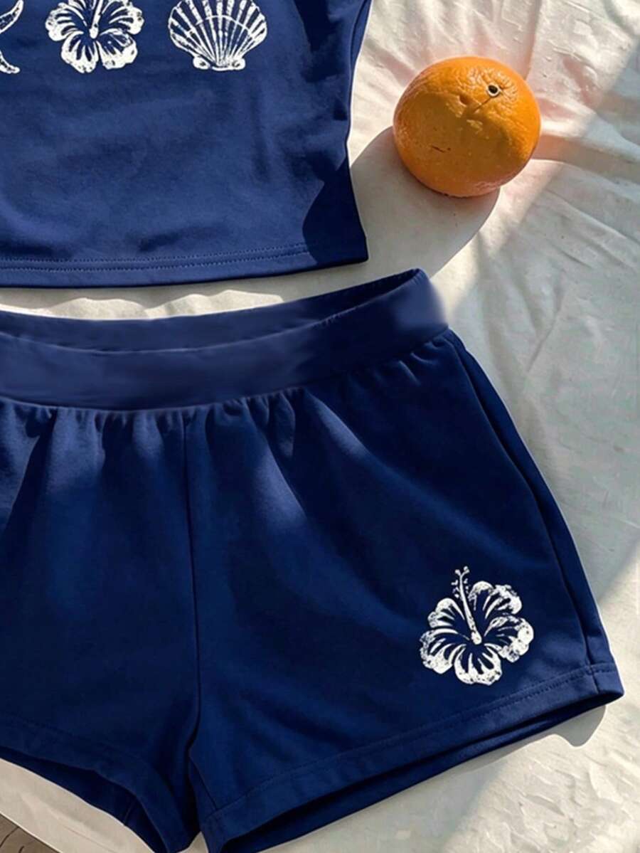 Tween girls summer 2-piece Hawaiian style outfit featuring a graphic print spaghetti strap camisole top with contrast piping and matching casual shorts.