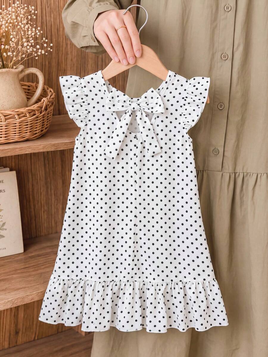 Tween girls apricot vacation midi dress featuring a round neck, cut out details, ruffle flounce accents, and geometric pattern.