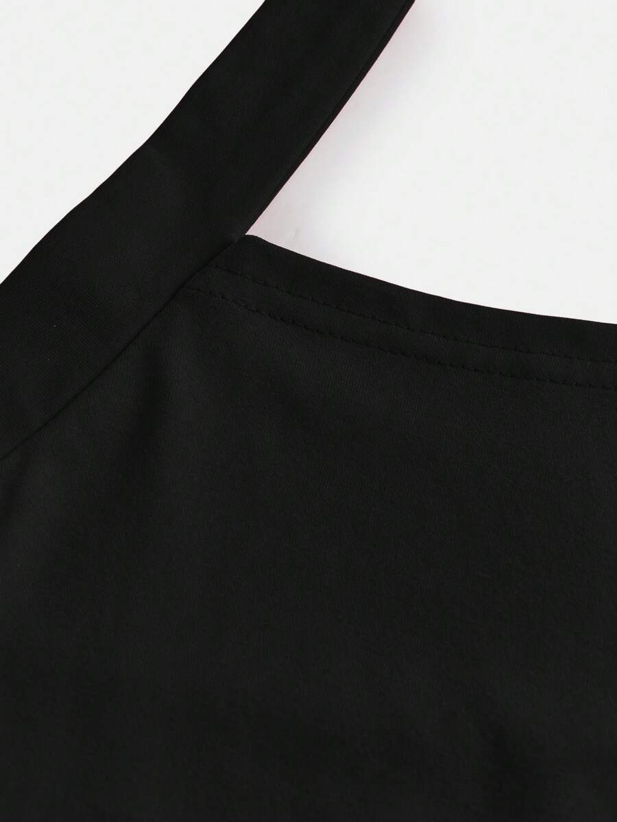 Black sleeveless halter polka dot mini dress for tween girls featuring a high waist and flared hem