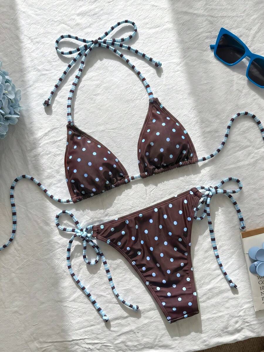 Women's black and white zebra print two-piece bikini set featuring a high waist tie-side bottom and a backless halter top with removable padding.