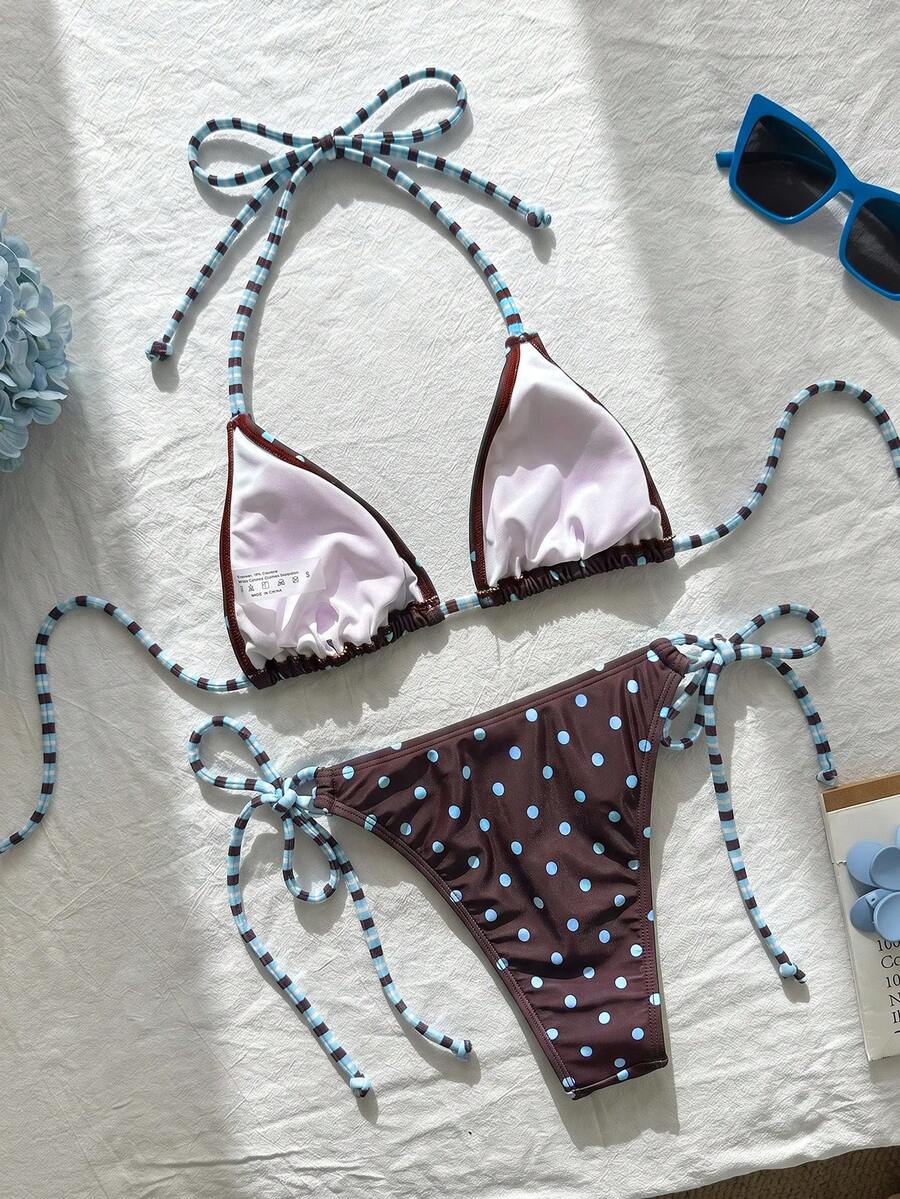 Women's black and white zebra print two-piece bikini set featuring a high waist tie-side bottom and a backless halter top with removable padding.