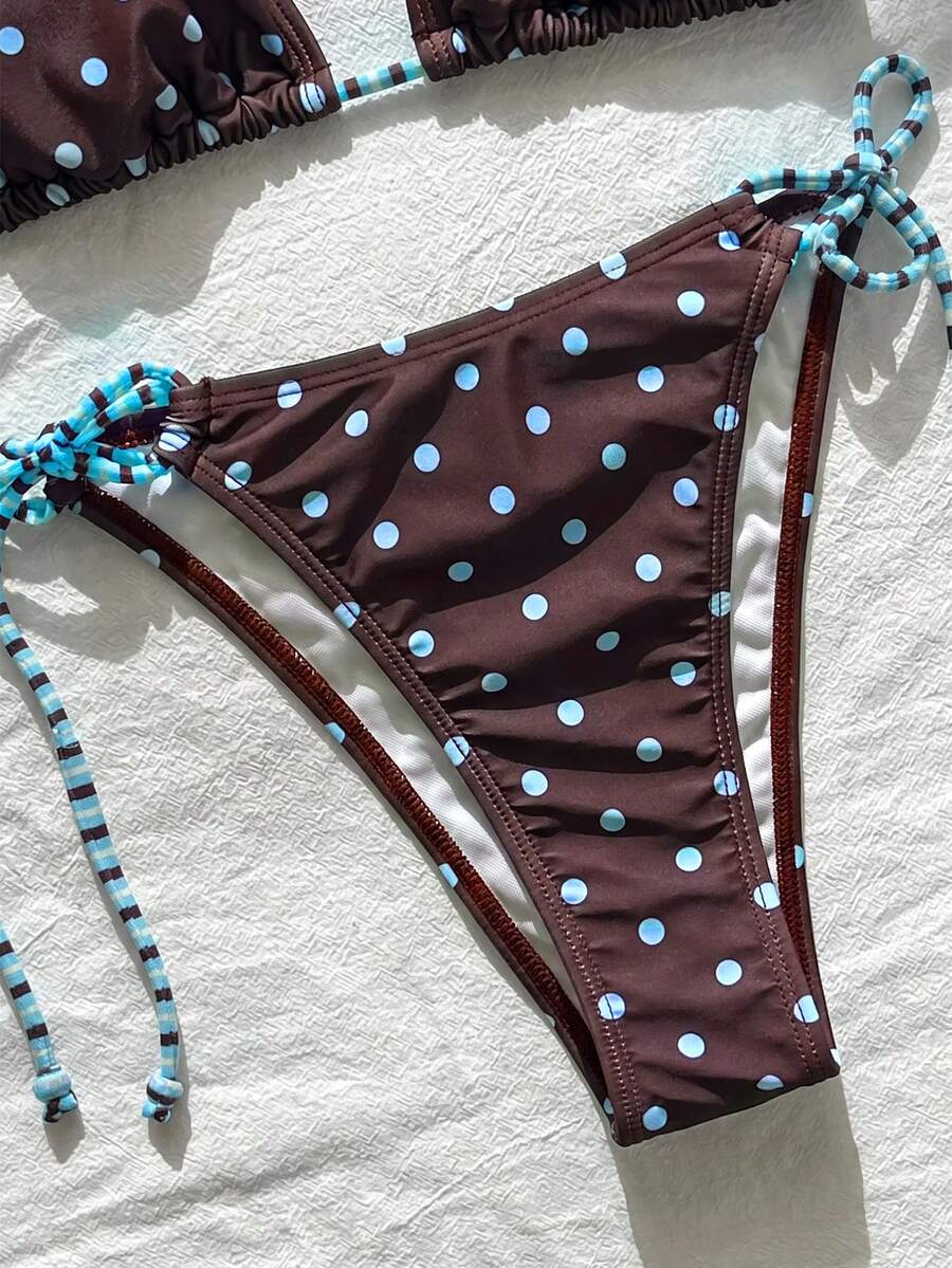Women's black and white zebra print two-piece bikini set featuring a high waist tie-side bottom and a backless halter top with removable padding.