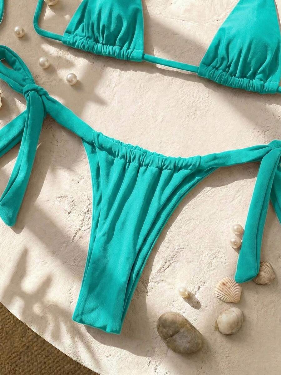 Army green high waist micro bikini swimsuit set for women featuring wireless spaghetti strap top with chain knot details and tie side thong bottoms.