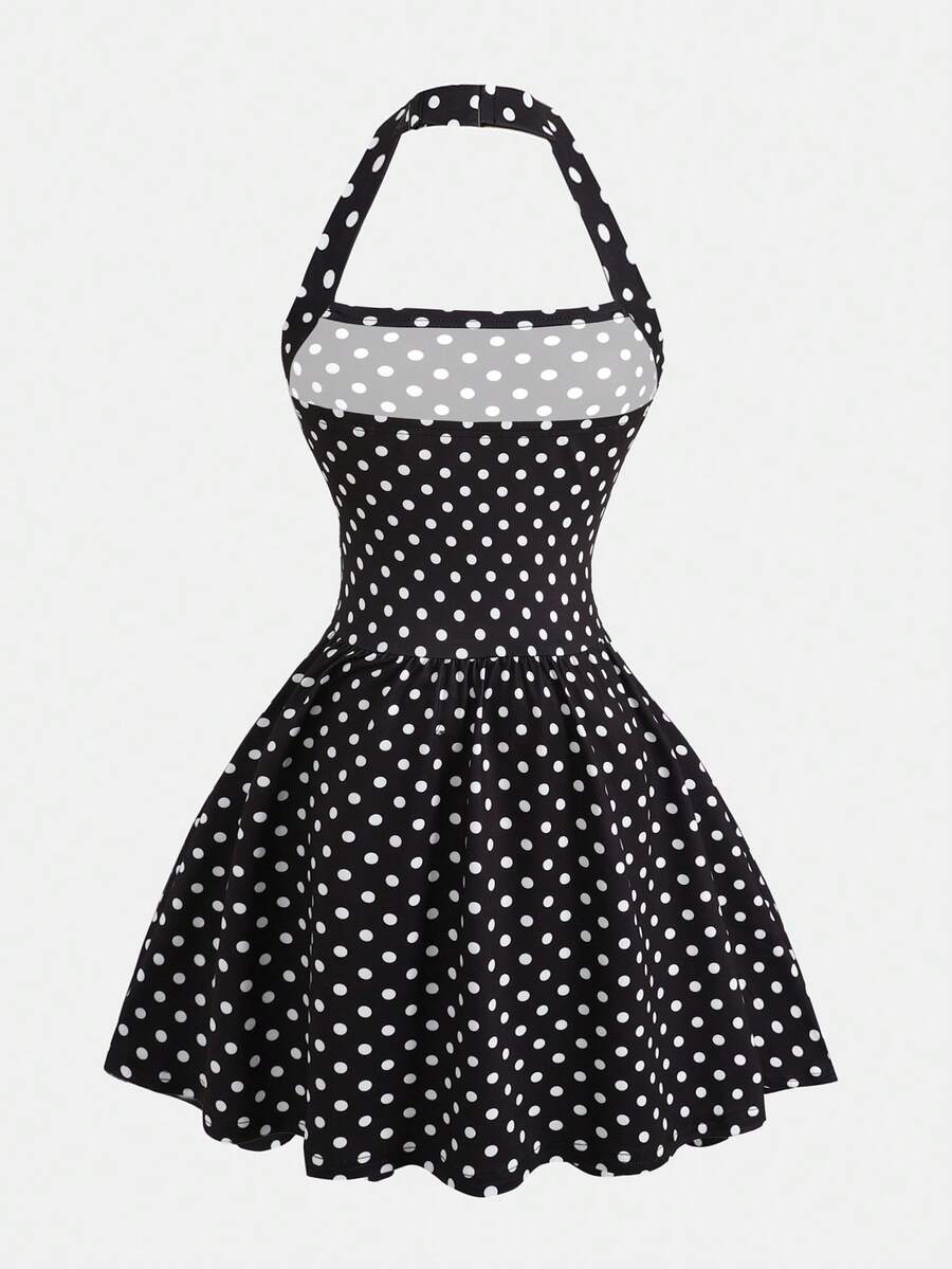 Black sleeveless halter polka dot mini dress for tween girls featuring a high waist and flared hem