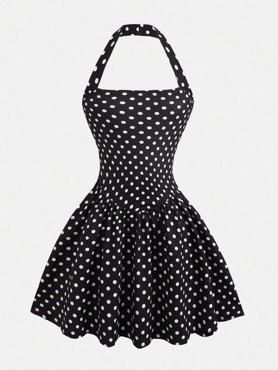 Black sleeveless halter polka dot mini dress for tween girls featuring a high waist and flared hem