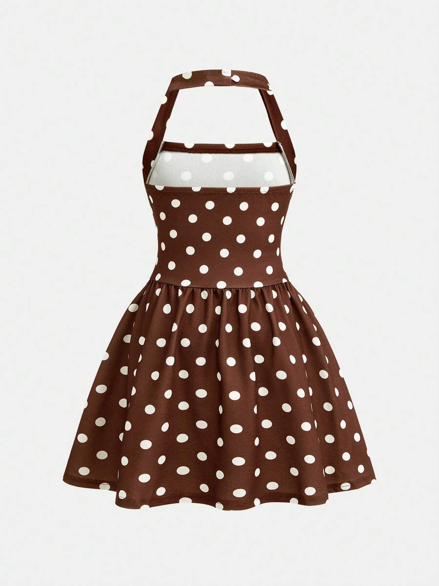 Black sleeveless halter polka dot mini dress for tween girls featuring a high waist and flared hem
