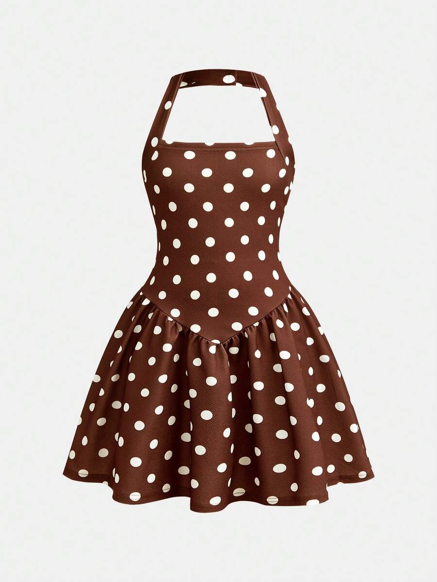 Black sleeveless halter polka dot mini dress for tween girls featuring a high waist and flared hem