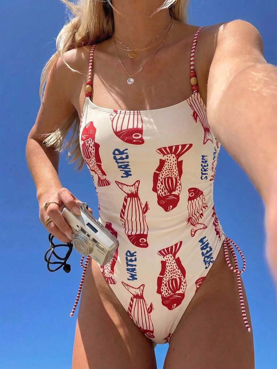 Women's blue backless one-piece swimsuit featuring spaghetti straps, wireless bra with removable padding, and drawstring details.