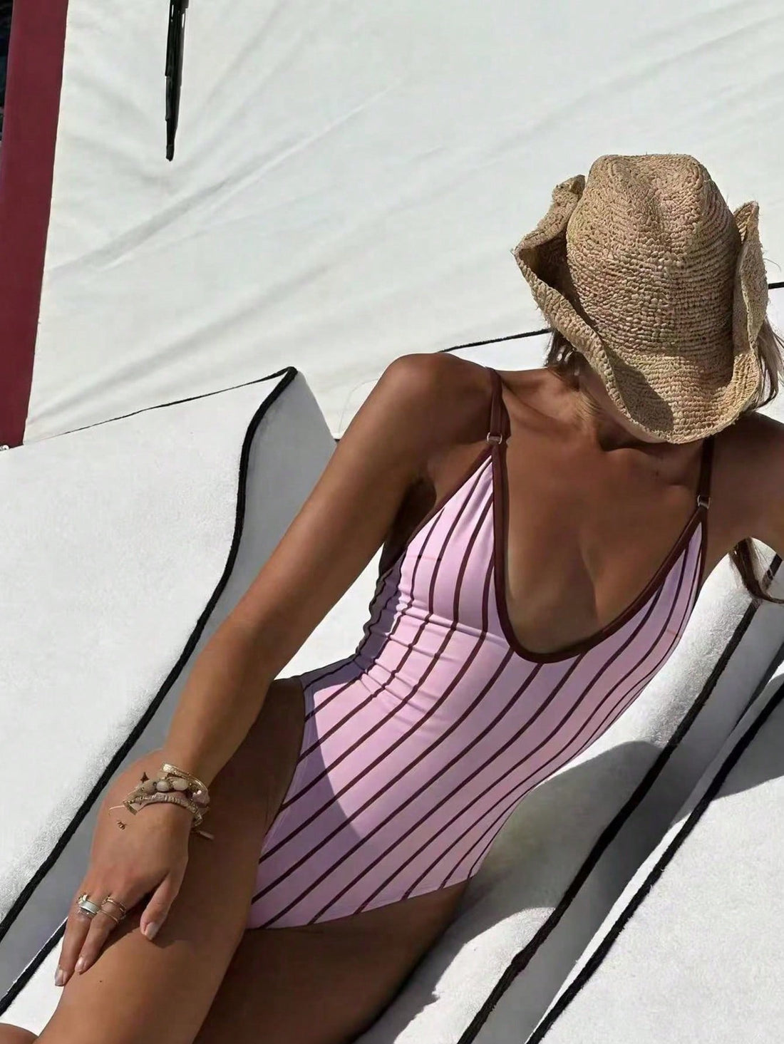 Women's vertical striped deep V one-piece swimsuit with spaghetti straps, backless design, and high stretch fabric.