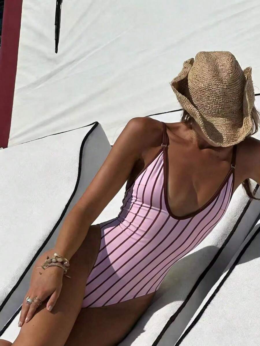 Women's vertical striped deep V one-piece swimsuit with spaghetti straps, backless design, and high stretch fabric.