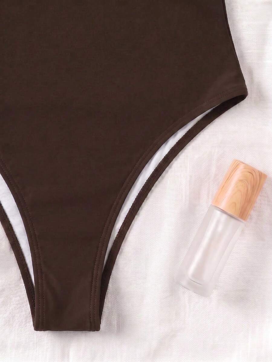 Black colorblock women's one-piece swimsuit with spaghetti straps and high stretch fabric.