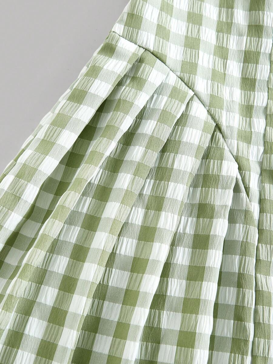 Tween girl green plaid modest sleeveless long dress featuring a round neckline, high waist, and flared A-line hem.