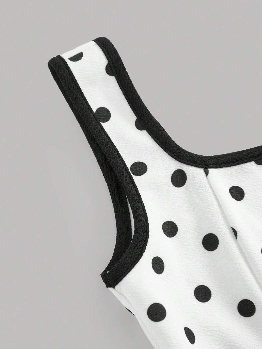 Black and white polka dot cami dress for tween girls featuring a square neckline, high waist, and flared short A-line hem.