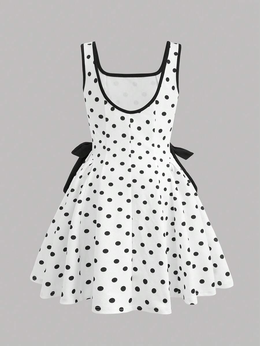 Black and white polka dot cami dress for tween girls featuring a square neckline, high waist, and flared short A-line hem.