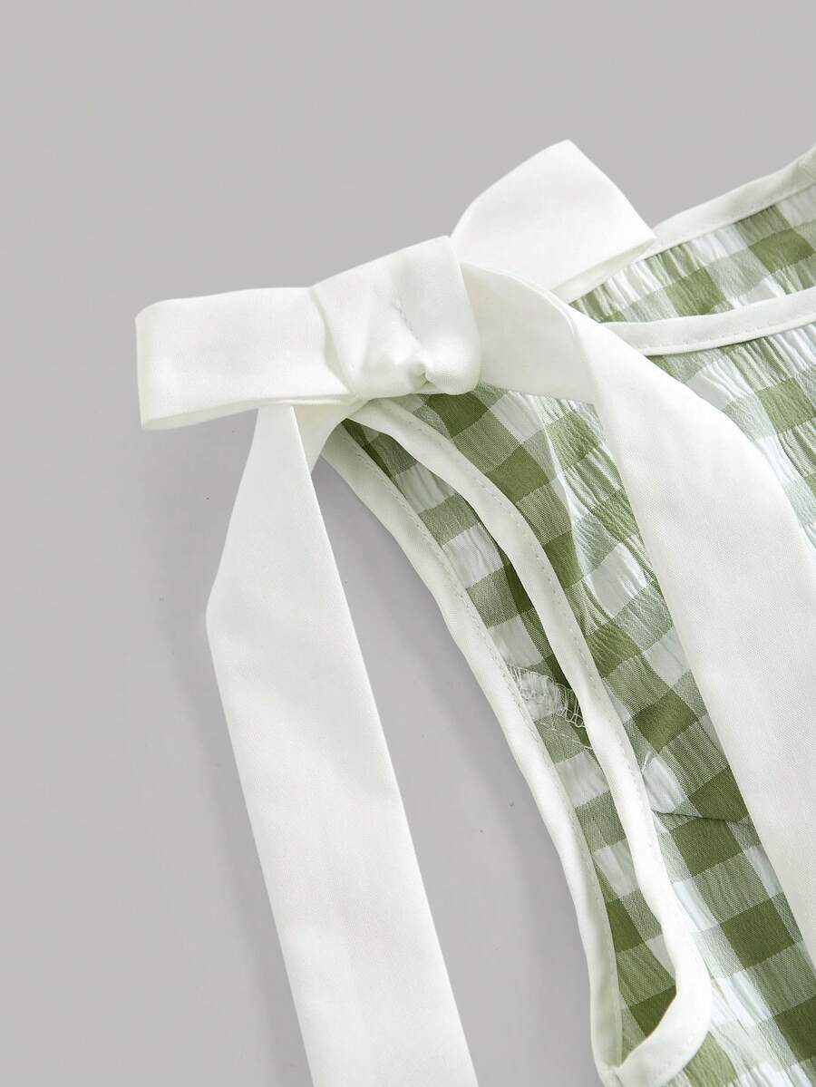 Tween girl green plaid modest sleeveless long dress featuring a round neckline, high waist, and flared A-line hem.