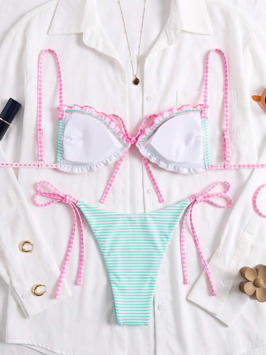 Women's beige two-piece bikini set featuring a wireless top with removable padding, spaghetti straps, tie back detail, and low waist hipster swimsuit bottoms.