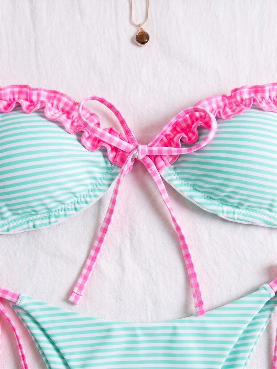 Women's beige two-piece bikini set featuring a wireless top with removable padding, spaghetti straps, tie back detail, and low waist hipster swimsuit bottoms.