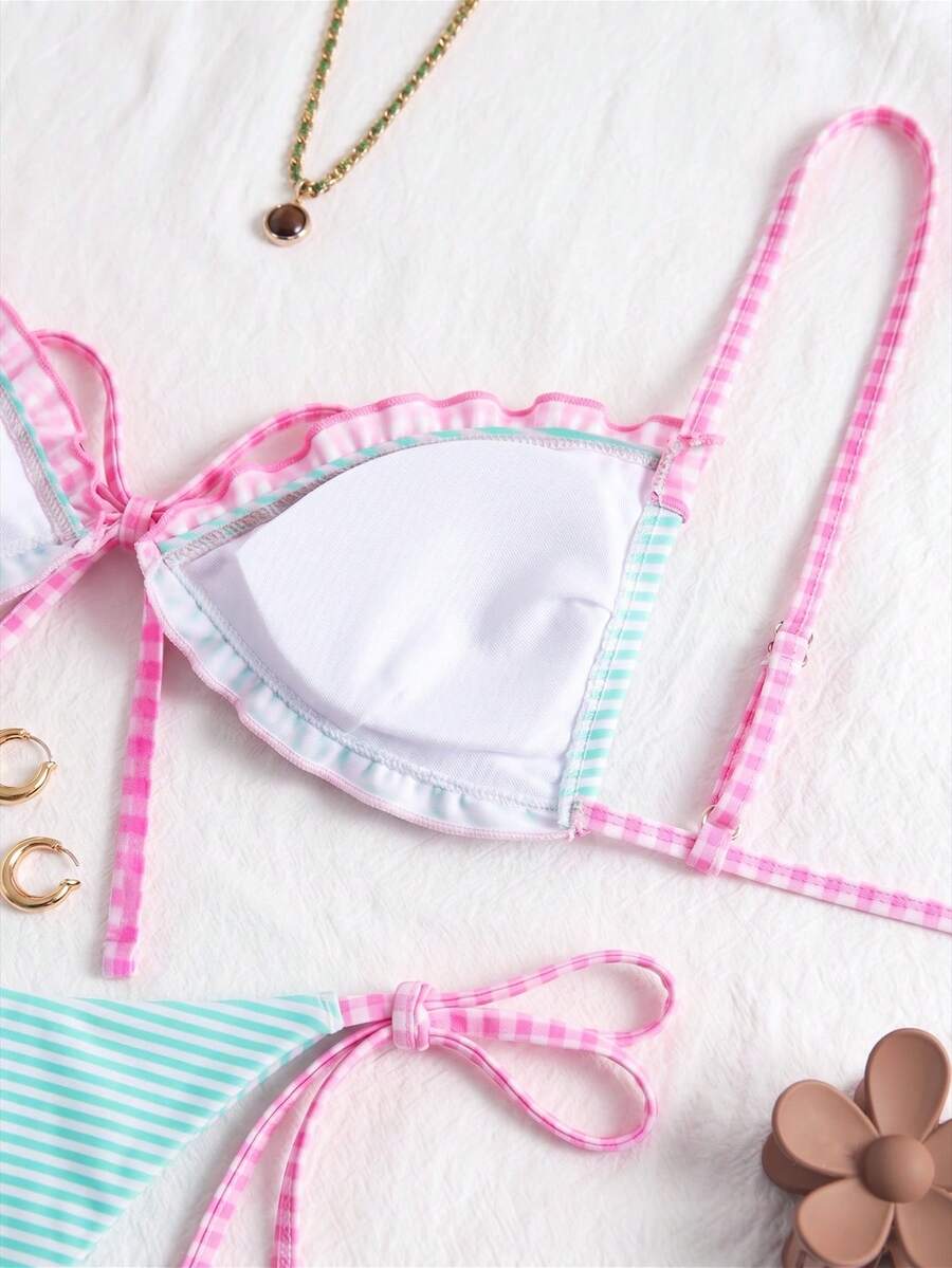 Women's beige two-piece bikini set featuring a wireless top with removable padding, spaghetti straps, tie back detail, and low waist hipster swimsuit bottoms.