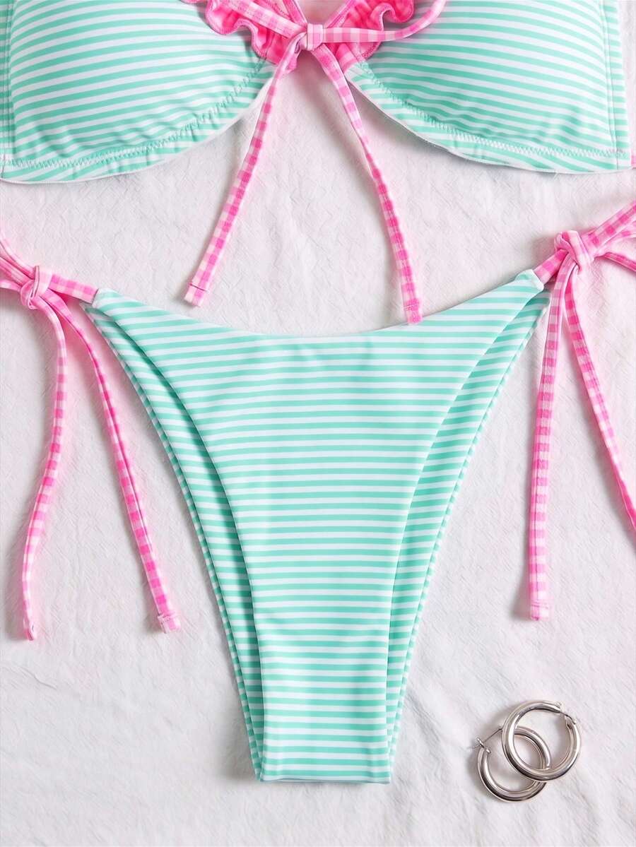 Women's beige two-piece bikini set featuring a wireless top with removable padding, spaghetti straps, tie back detail, and low waist hipster swimsuit bottoms.