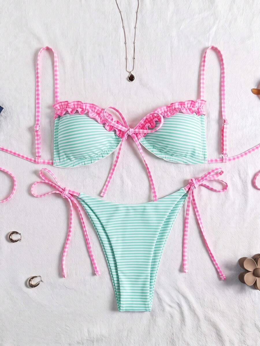 Women's beige two-piece bikini set featuring a wireless top with removable padding, spaghetti straps, tie back detail, and low waist hipster swimsuit bottoms.