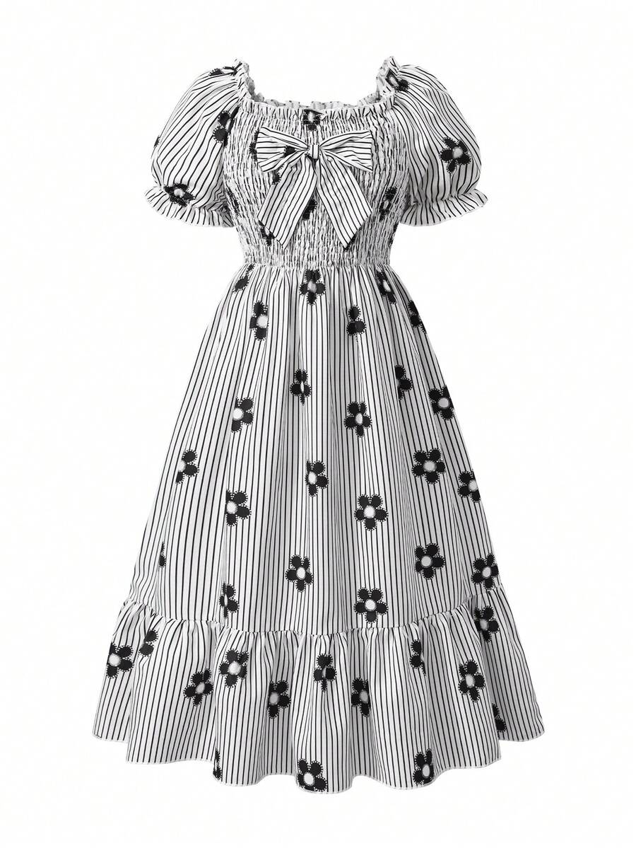 Tween girl wearing a black and white off-the-shoulder floral midi dress featuring short puff sleeves, high waist, and flounce hem.