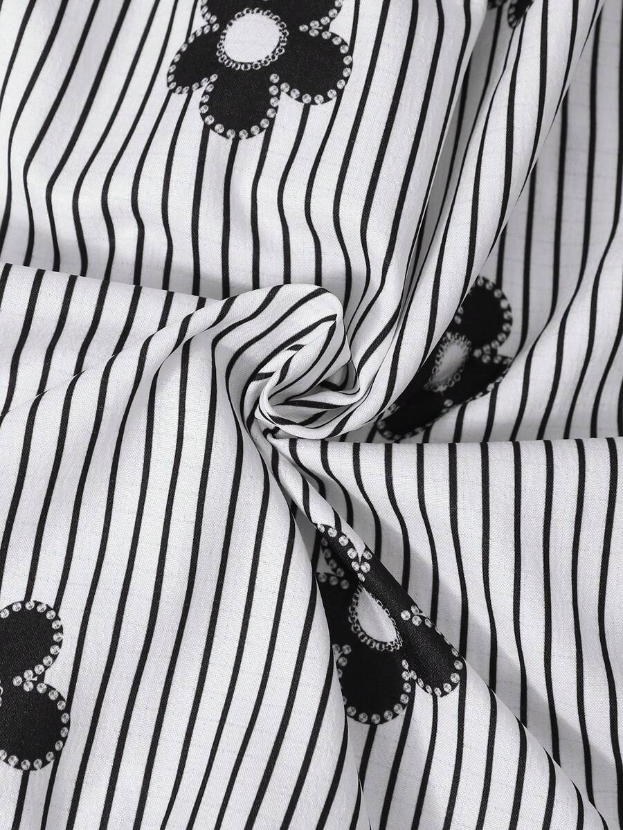 Tween girl wearing a black and white off-the-shoulder floral midi dress featuring short puff sleeves, high waist, and flounce hem.
