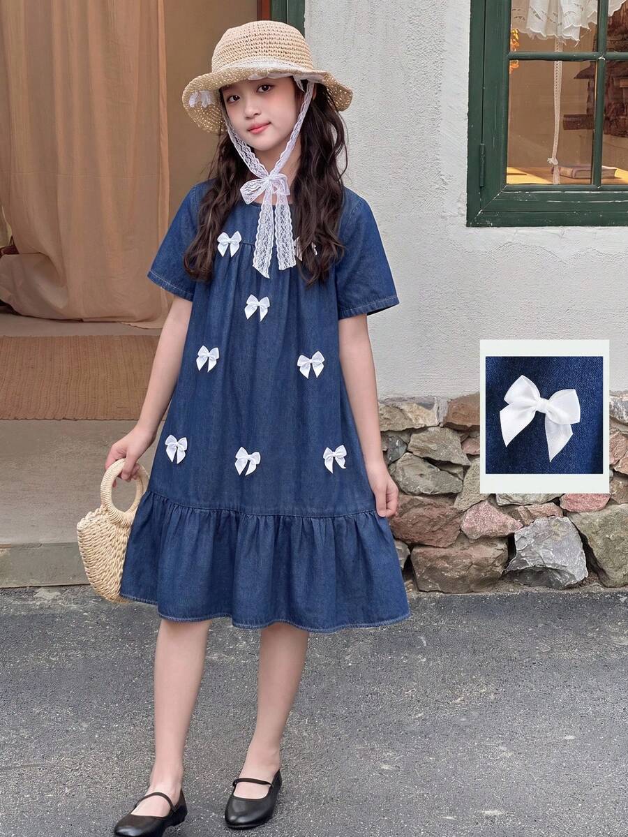 Tween girl wearing an Army Green textured short sleeve smock midi dress with round neck and ruffle flounce hem.