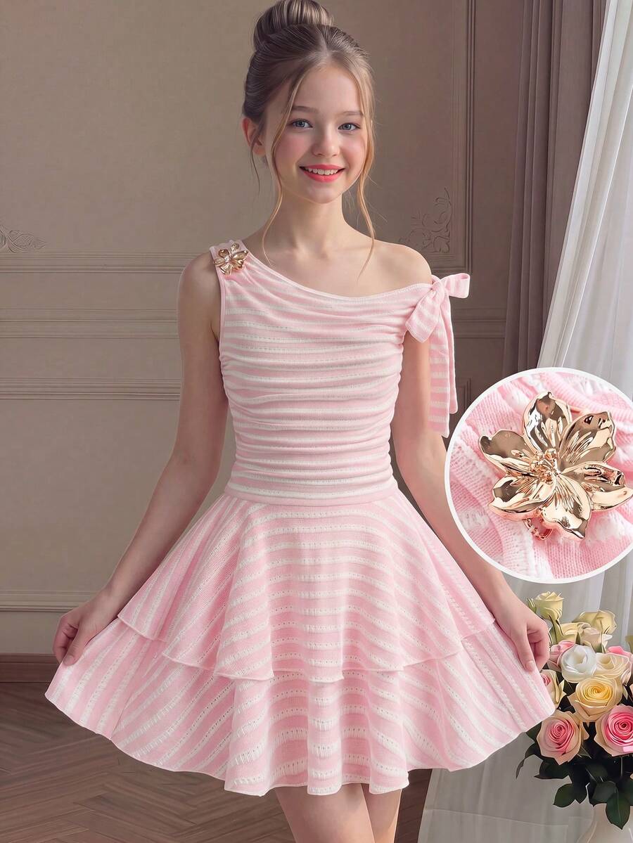 Tween girl wearing an apricot asymmetrical tiered sleeveless party dress with an A-line silhouette.