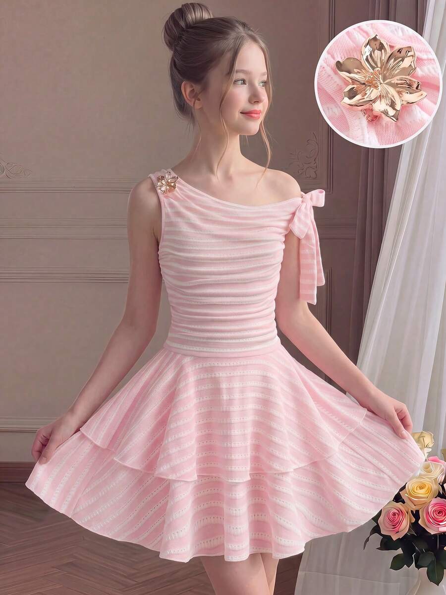 Tween girl wearing an apricot asymmetrical tiered sleeveless party dress with an A-line silhouette.