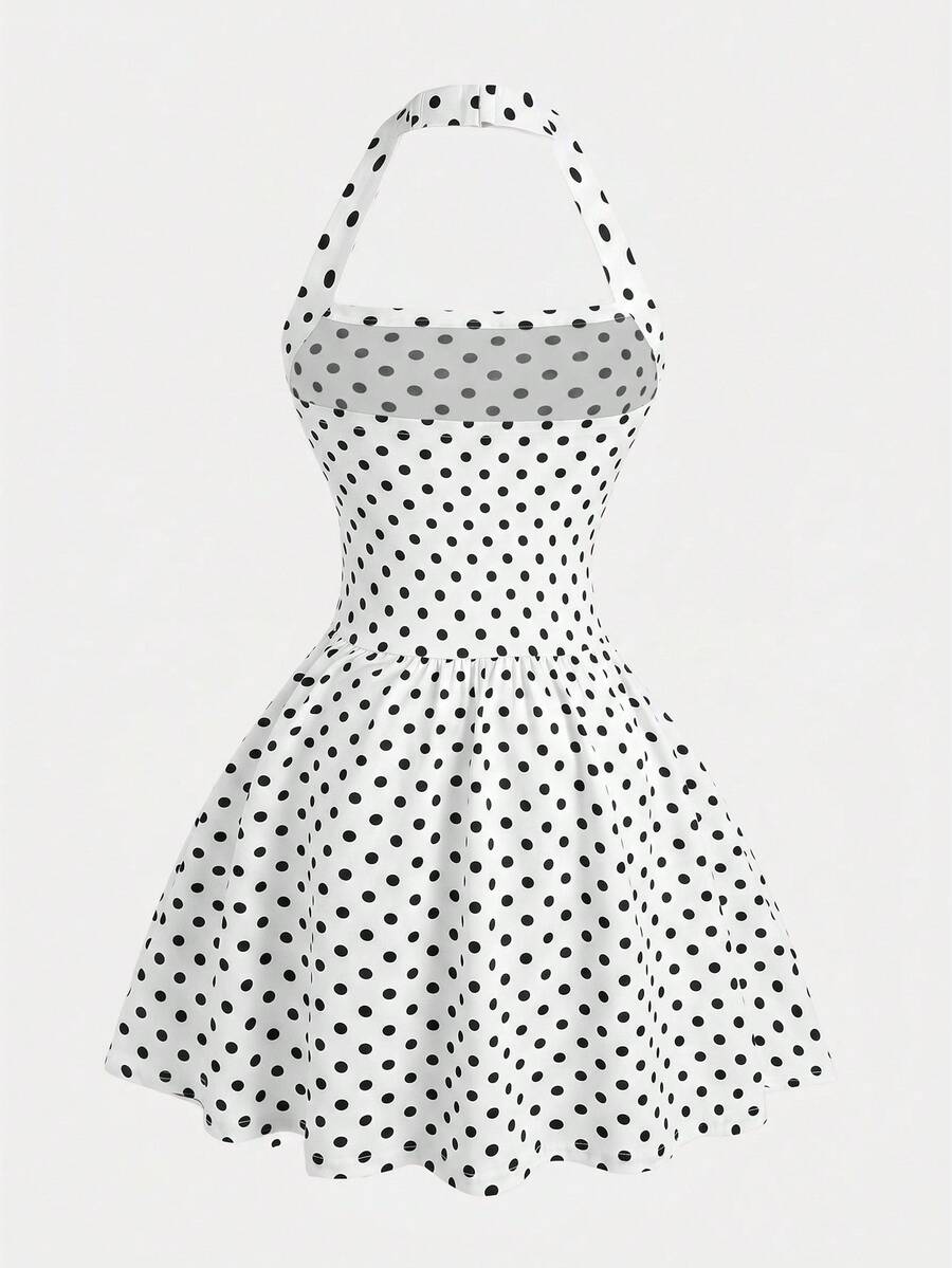 Black sleeveless halter polka dot mini dress for tween girls featuring a high waist and flared hem